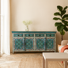 Lifestyle imagination of a hand painted furniture sideboard made from reclaimed teak wood with floral motifs, artisanal furniture in bohemian Mediterranean style, 180 × 40 × 90 cm.