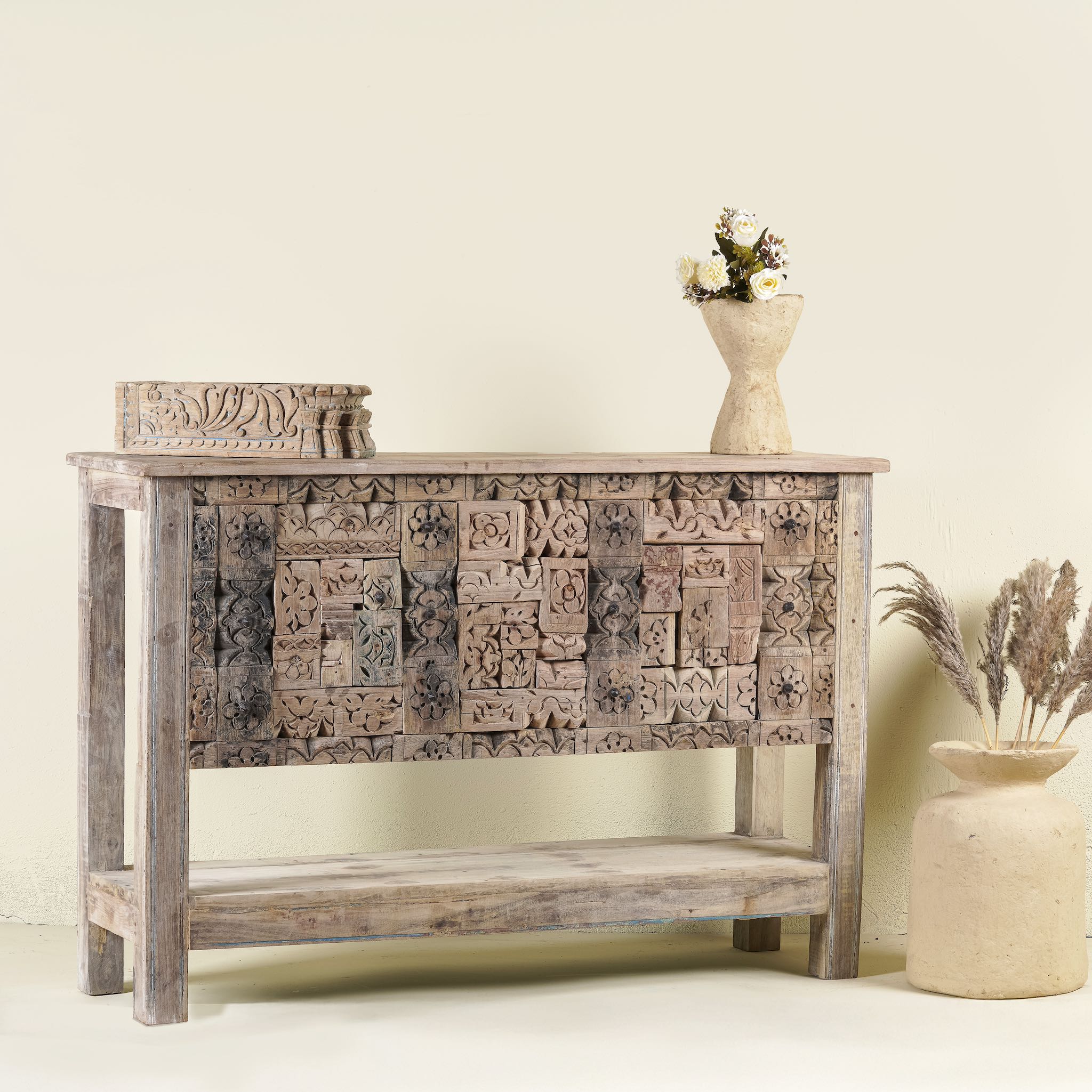 Side angle image of a reclaimed teak console table with hand-carved antique elements and rustic finish, 140 × 38 × 93 cm.