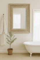 Lifestyle imagination of a vintage wall mirror with hand carved wooden mango wood frame; large rectangular mirror, 100 × 130 cm.