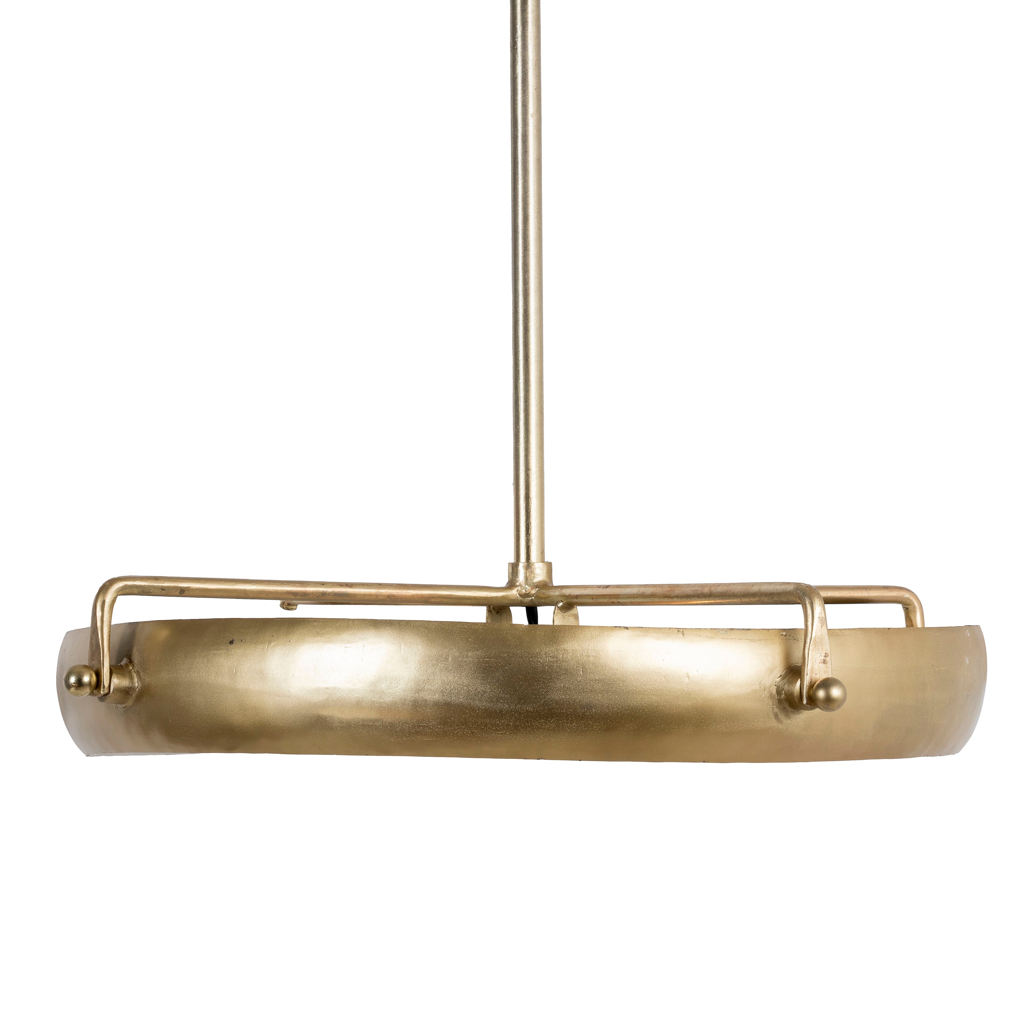 A round vintage pendant lamp with a brass-plated iron frame and a clear glass shade, featuring a warm, inviting light diffusion.