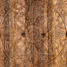 Close up image of a Mango wood wardrobe with hand-carved floral detailing, Indian carved wooden furniture with bottom drawer, 105 × 40 × 180 cm.