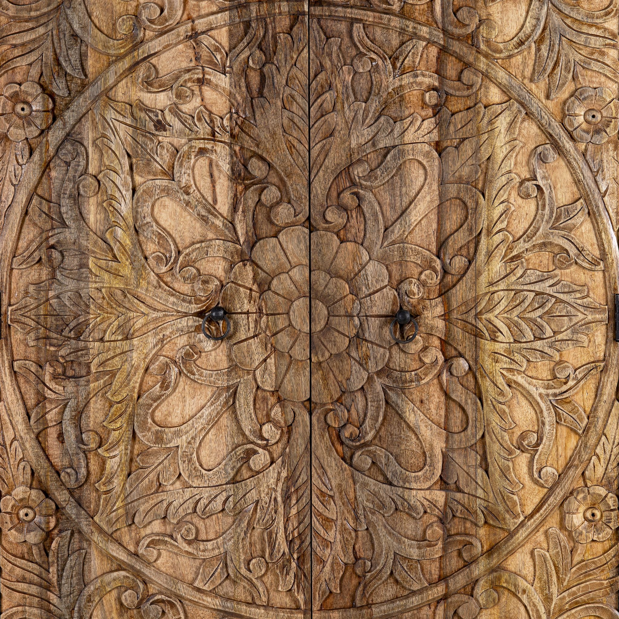 Close up image of a Mango wood wardrobe with hand-carved floral detailing, Indian carved wooden furniture with bottom drawer, 105 × 40 × 180 cm.