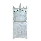 White background image of a Shivani mango wood house temple in whitewashed finish with carved floral doors and traditional arched canopy—an elegant example of hand-carved Mandirs and Indian home temples.