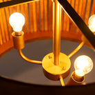 Close up image of a large rustic pendant lamp made of natural mango wood with brass-clad edges – minimalistic style lighting ideal for dining rooms, kitchens, or spacious living areas.