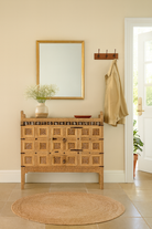 Lifestyle image of a vintage entryway table treasure chest in antique Indian furniture style, solid teak wood with iron accents and sandblasted finish, 113 × 54 × 100 cm.