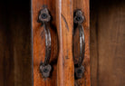 Close up image of a compact reclaimed teak wood display cabinet with two glass doors and shelving – sustainable teak wood furniture combining functional design and unique character.