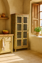 Lifestyle image of a hand-painted reclaimed wood showcase cabinet with floral motifs and glass doors, sustainable furniture and vintage home decor style, 95 × 48 × 183 cm.