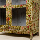 Close up image of a hand-painted reclaimed wood showcase cabinet with floral motifs and glass doors, sustainable furniture and vintage home decor style, 95 × 48 × 183 cm.