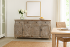 Lifestyle image of a living room furniture sideboard made from hand-carved mango wood, vintage style furniture with sunburst patterns and distressed finish, 180 × 40 × 90 cm.
