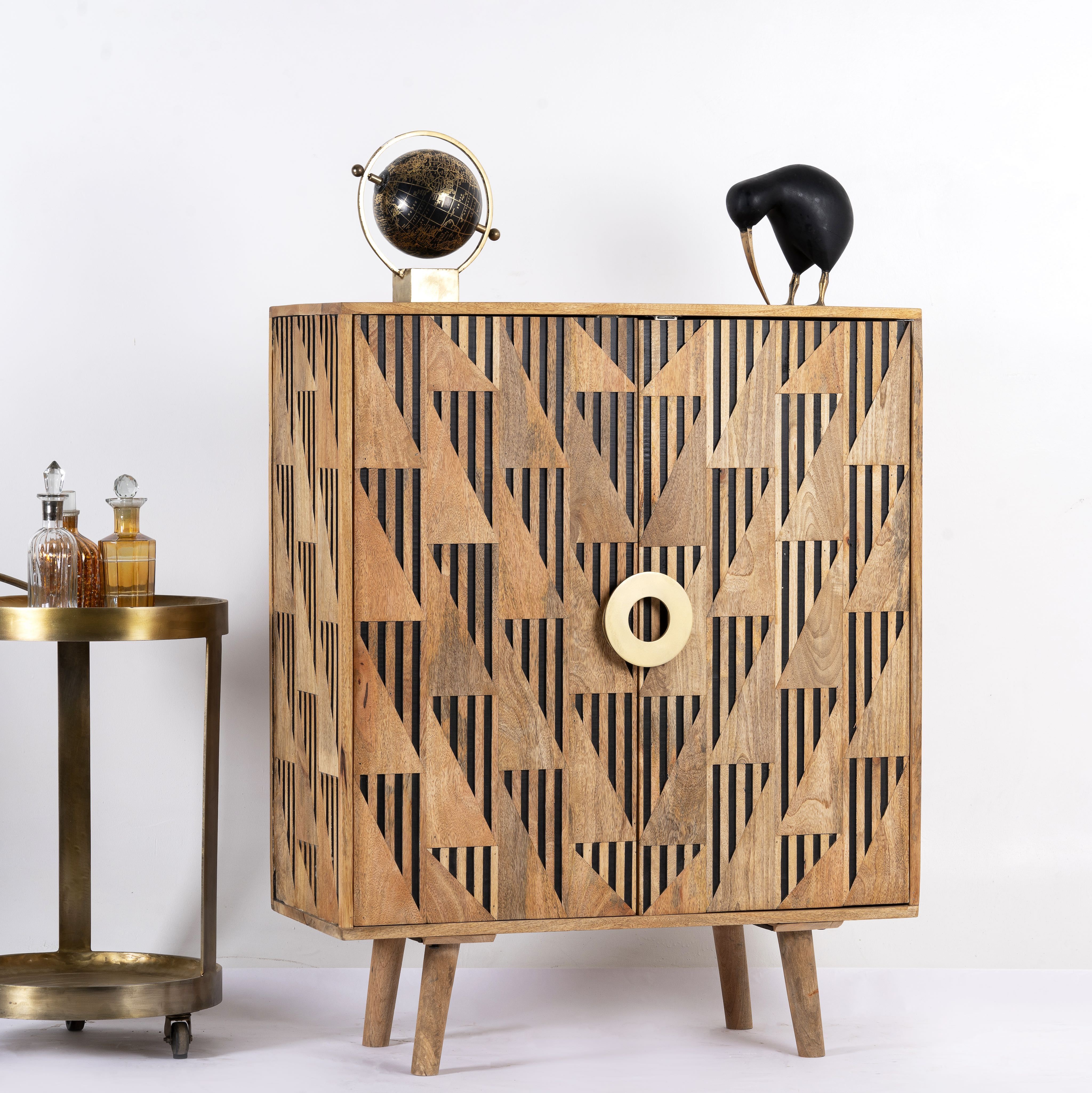 Side angle image of a artisanal mango wood cabinet with natural doors, black frame, and brass knobs, 91 × 113 × 41 cm.