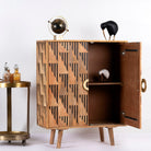 side angle image of a artisanal mango wood cabinet with natural doors, black frame, and brass knobs, 91 × 113 × 41 cm.