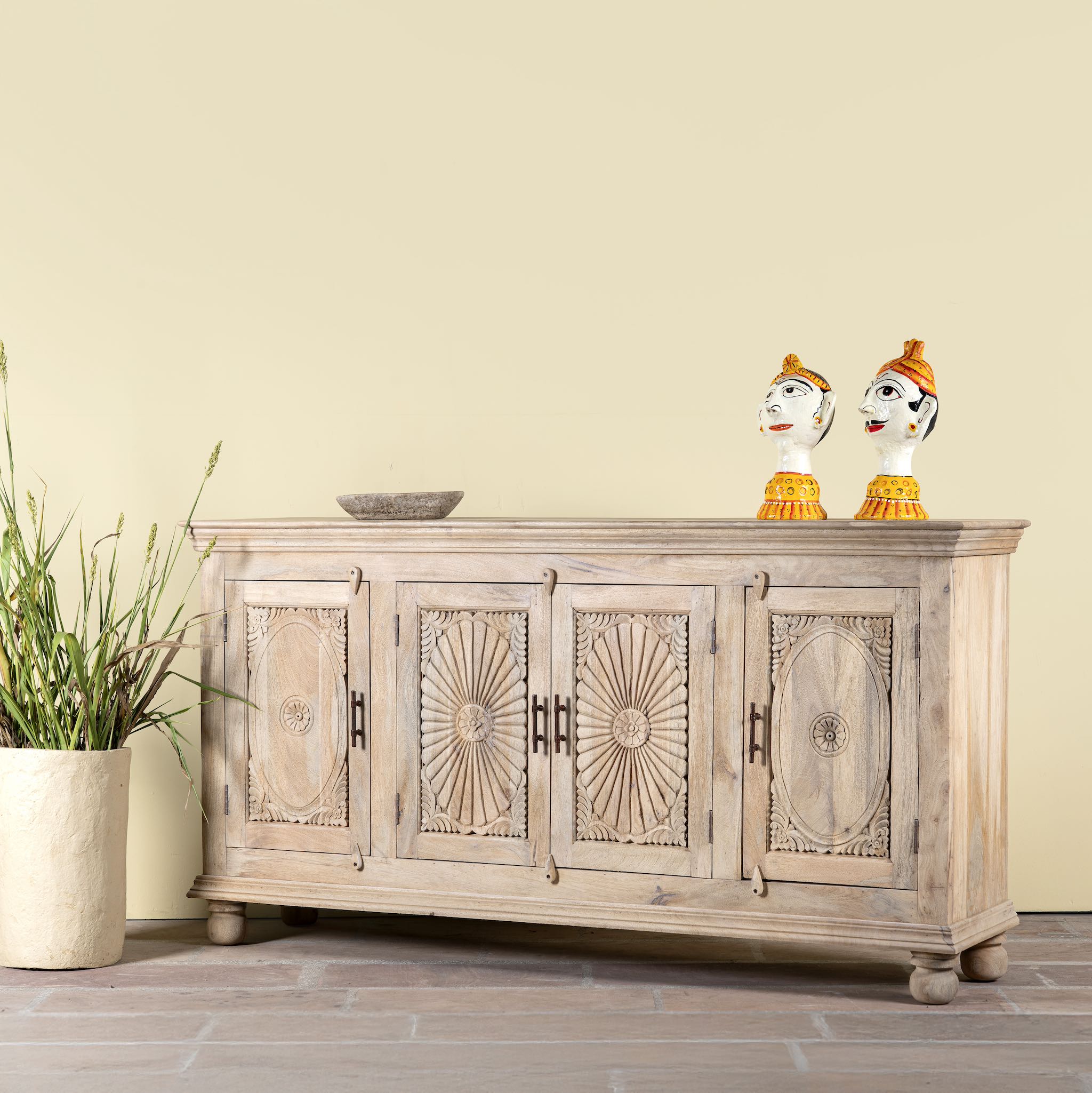 Side angle image of a hand-carved mango wood sideboard with sandblasted finish – a rustic mango wood furniture piece ideal for Ibiza style interiors.