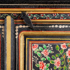 Close up image of a hand-painted cabinet made from recycled wood with floral motifs – sustainable furniture and unique furniture for bold, artistic interiors.