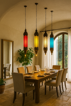 Lifestyle image of a tall oriental pendant lamp Ovin made from punched metal and coloured Belgium glass – 100 cm hanging lantern in red, yellow, white, and blue for vibrant atmospheric lighting.