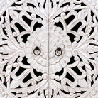 Close up image of a white carved wood cabinet made from solid mango wood with hand-carved Indian motifs, 90 × 90 × 40 cm.