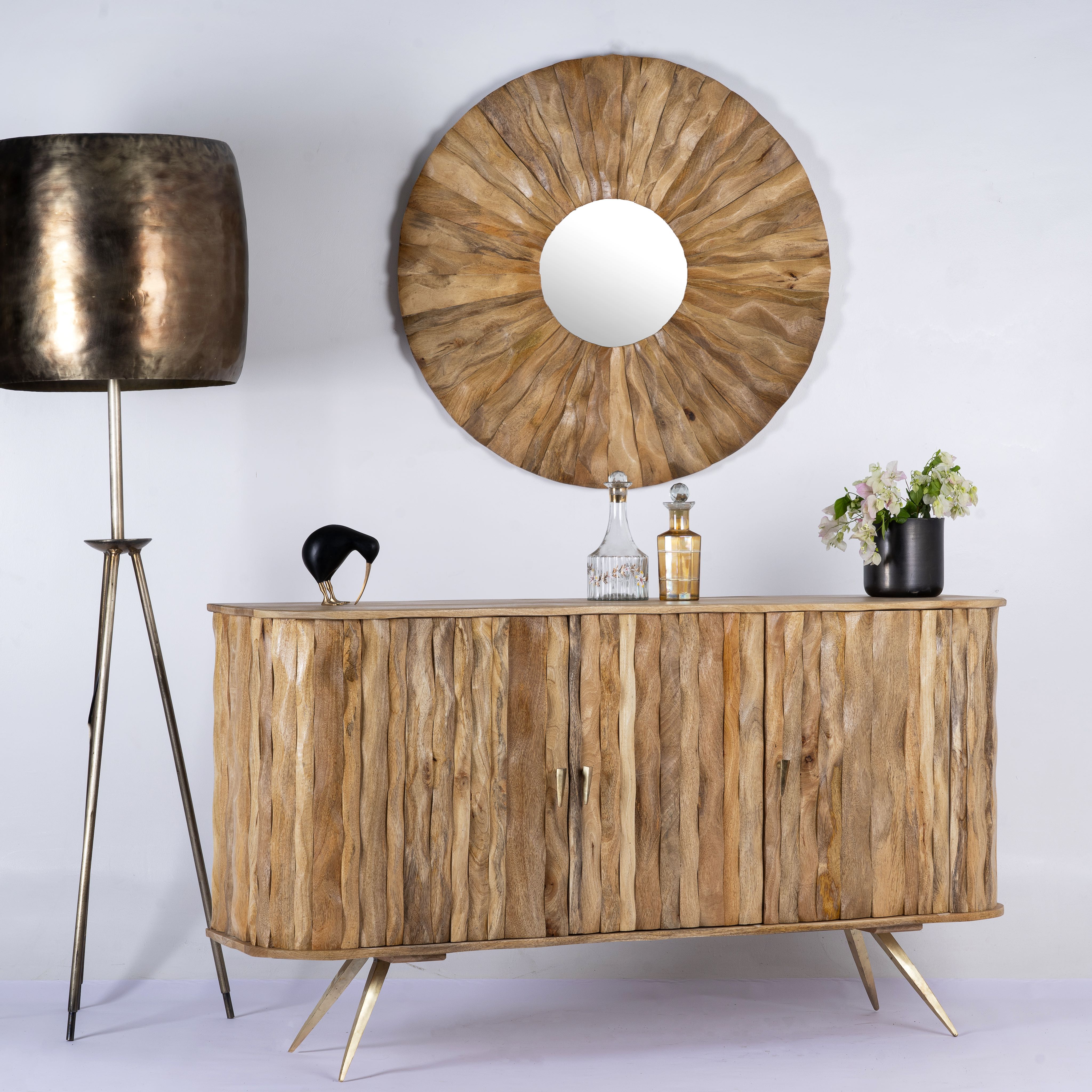 Side angle image of a handmade mango wood sideboard with live-edge design, brass-coated base, and handles—an artisanal furniture piece combining natural and modern elements.
