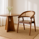 Lifestyle imagination of an acacia wood chair with curved frame and woven rattan backrest, elegant wooden armchair, 60 × 45 × 90 cm.