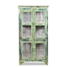 White background image of a refurbished teak wood showcase with distressed green finish – sustainable furniture with boho style interior appeal and glass-panelled storage.