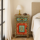 Lifestyle scene with a hand-painted bedside tables made from recycled wood – vintage night stands with carved mango wood furniture detailing and floral artistry.
