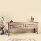 Side angle picture of a carved console table made from reclaimed teak, a refined example of unique wooden furniture.