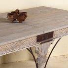 Close up image of a teak wood dining table with six hand-carved pillar legs; reclaimed Indian dining table, 180 × 90 × 75 cm.