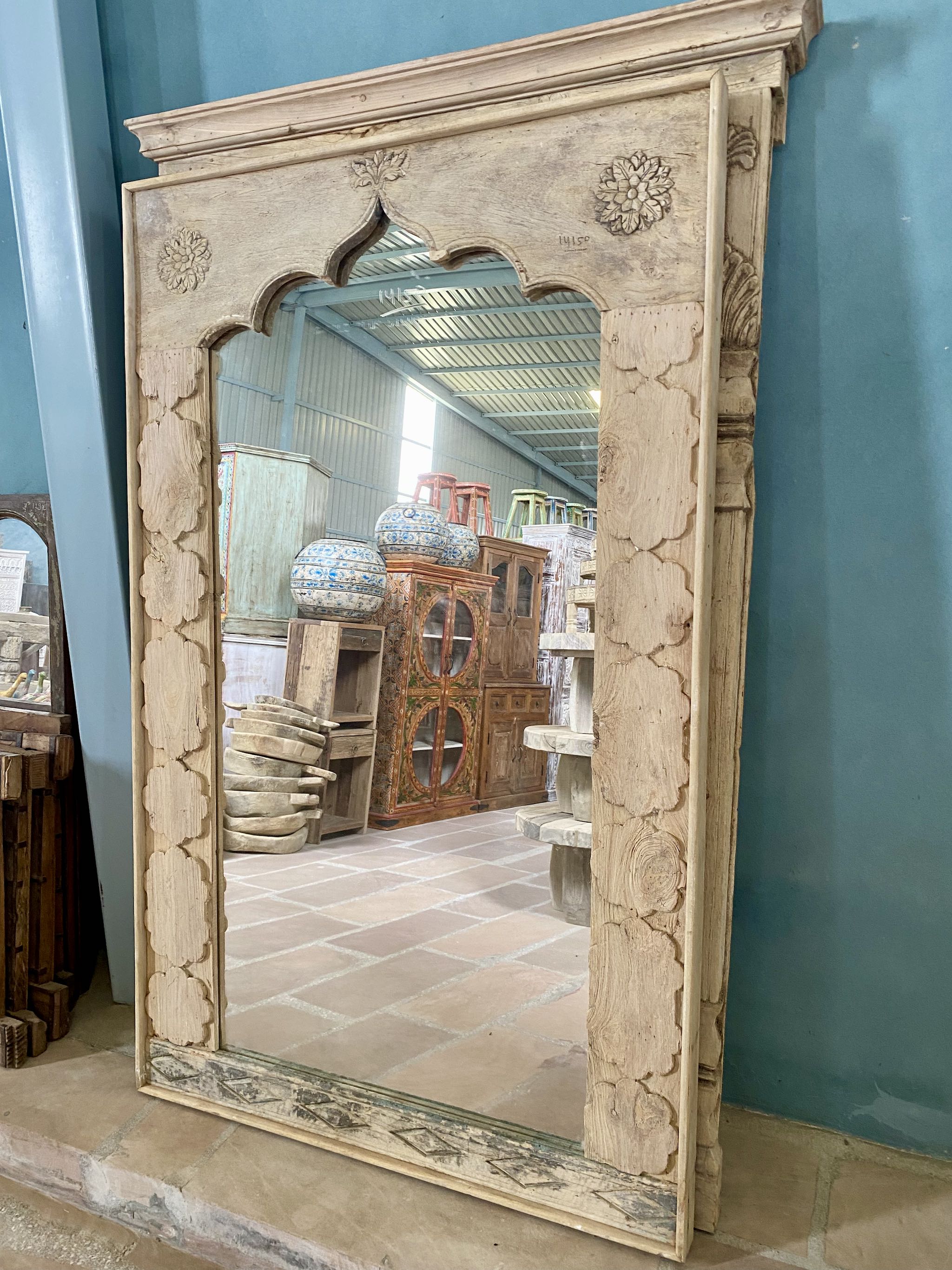 Large wall mirror made from reclaimed teak wood with a minimalist design and handcrafted carvings inspired by Indian artistry.