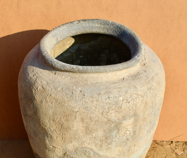Close up image of a antique Indian clay vase with aged finish – a Bali style clay vase ideal for Indian home decoration and boho-inspired interiors.