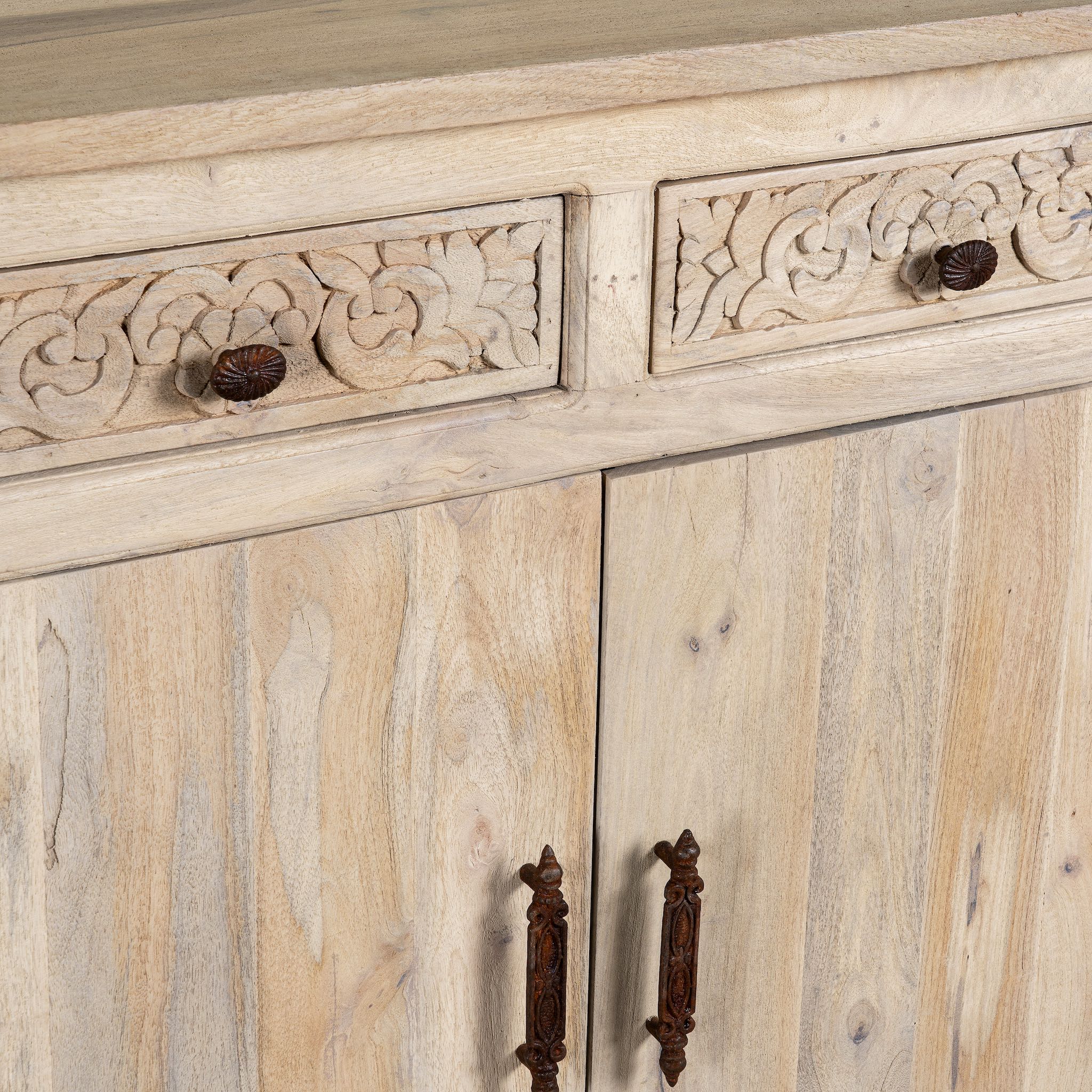 Closed up image of a hand-carved mango wood sideboard with sandblasted finish – a rustic mango wood furniture piece ideal for Ibiza style interiors.