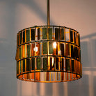 Lighted version of a Large round brass-plated iron pendant lamp with ornate tile surface – vintage lighting and iron pendant light ideal for dining rooms or living spaces.