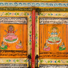 Close up image of a hand-painted reclaimed wood cabinet with Indian gods, floral motifs, and distressed finish; unique furniture for vintage home decor, 90 × 40 × 150 cm.