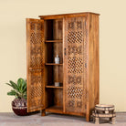 Side angle image showing a open door of a hand-carved mango wood wardrobe with floral and lattice motifs – a detailed piece of carved wood furniture ideal for natural mango wood interiors.