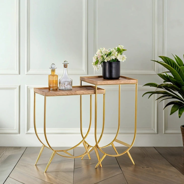 Lifestyle image of a metal base side table with U-shaped brass-coated iron frame and mango wood tray top; wooden top side table, 38 × 38 × 75 cm.