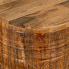 Close up picture of a elegant round hand carved coffee table made of sustainable Mango wood with floral design and black marble top.