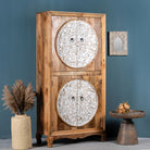 Side angle image of a mango wood wardrobe with hand-carved floral front, vintage carved wood furniture with curved legs, 180 × 90 × 40 cm.