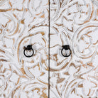 Close up image of a mango wood wardrobe with hand-carved floral front, vintage carved wood furniture with curved legs, 180 × 90 × 40 cm.