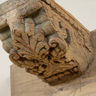 Close up image of a unique wall shelf made of reclaimed teak wood with carved supports from Indian house parts; rustic vintage home accessories, 100 × 20 × 15 cm.