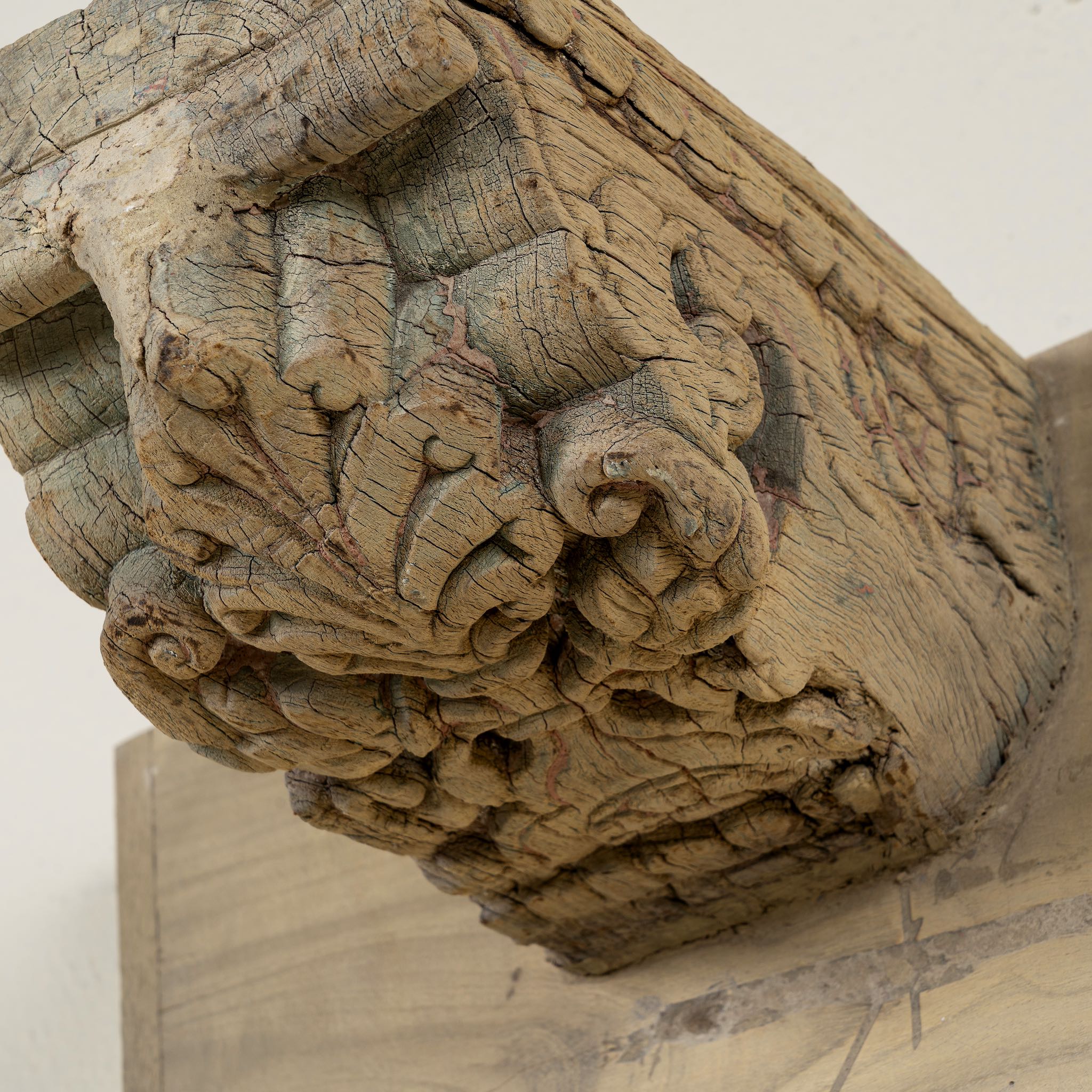 Close up image of a unique wall shelf made of reclaimed teak wood with carved supports from Indian house parts; rustic vintage home accessories, 100 × 20 × 15 cm.