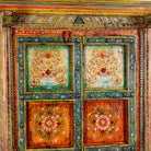 Close up image of a hand-painted teak wood cabinet with floral motifs; teak wood furniture for bohemian interiors, 105 × 55 × 177 cm.