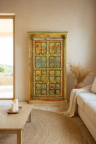 Lifestyle image of a hand painted wardrobe made of teak wood with floral motifs; unique furniture inspired by Indian artistry, 104 × 50 × 186 cm.