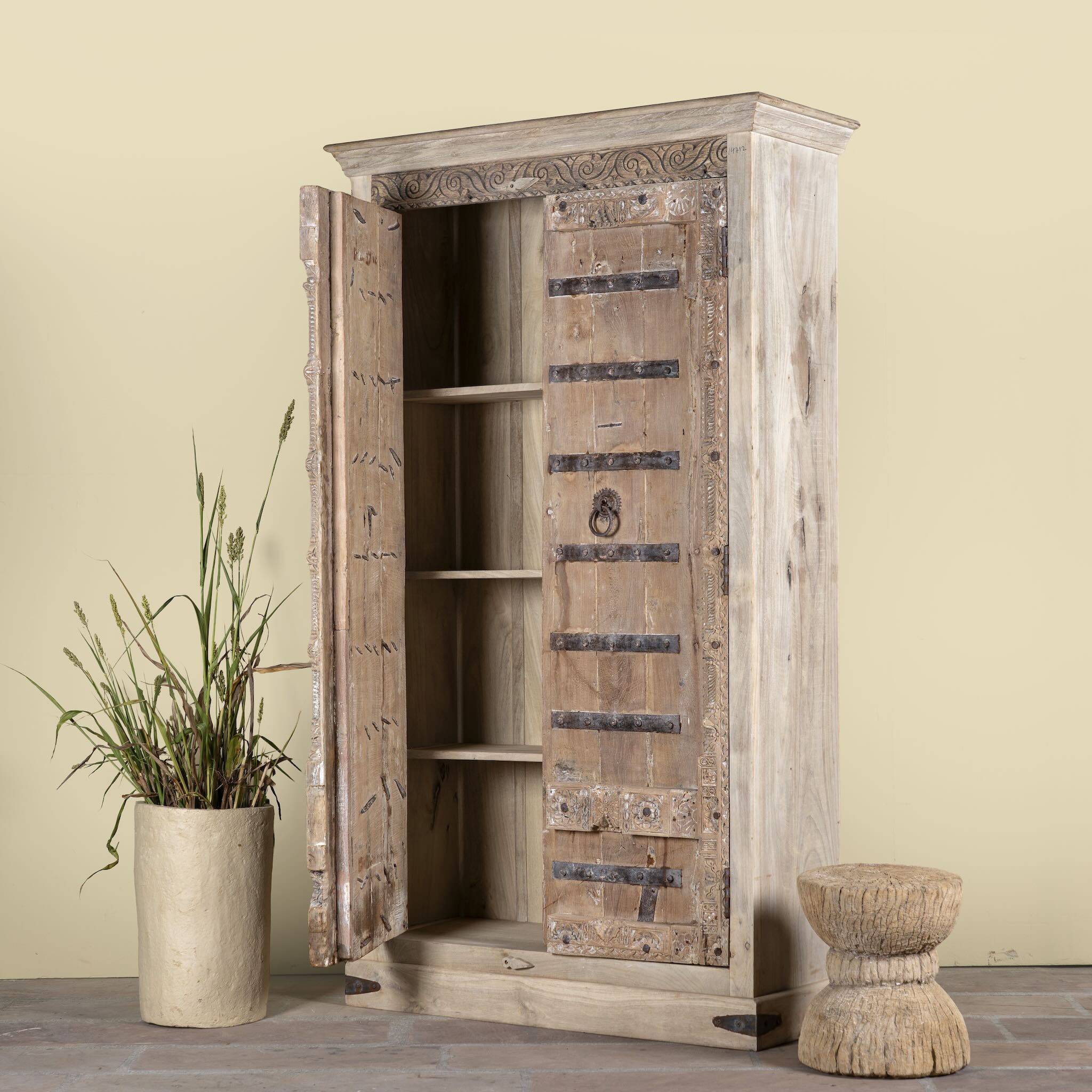 Side angle image with open doors of a hand-carved teak wood wardrobe with original iron fittings – Veena model by Om Home & Garden