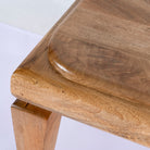 Close up image of a minimalistic mango wood bench with natural finish and clean design; versatile wooden seating, 180 × 41 × 44 cm.