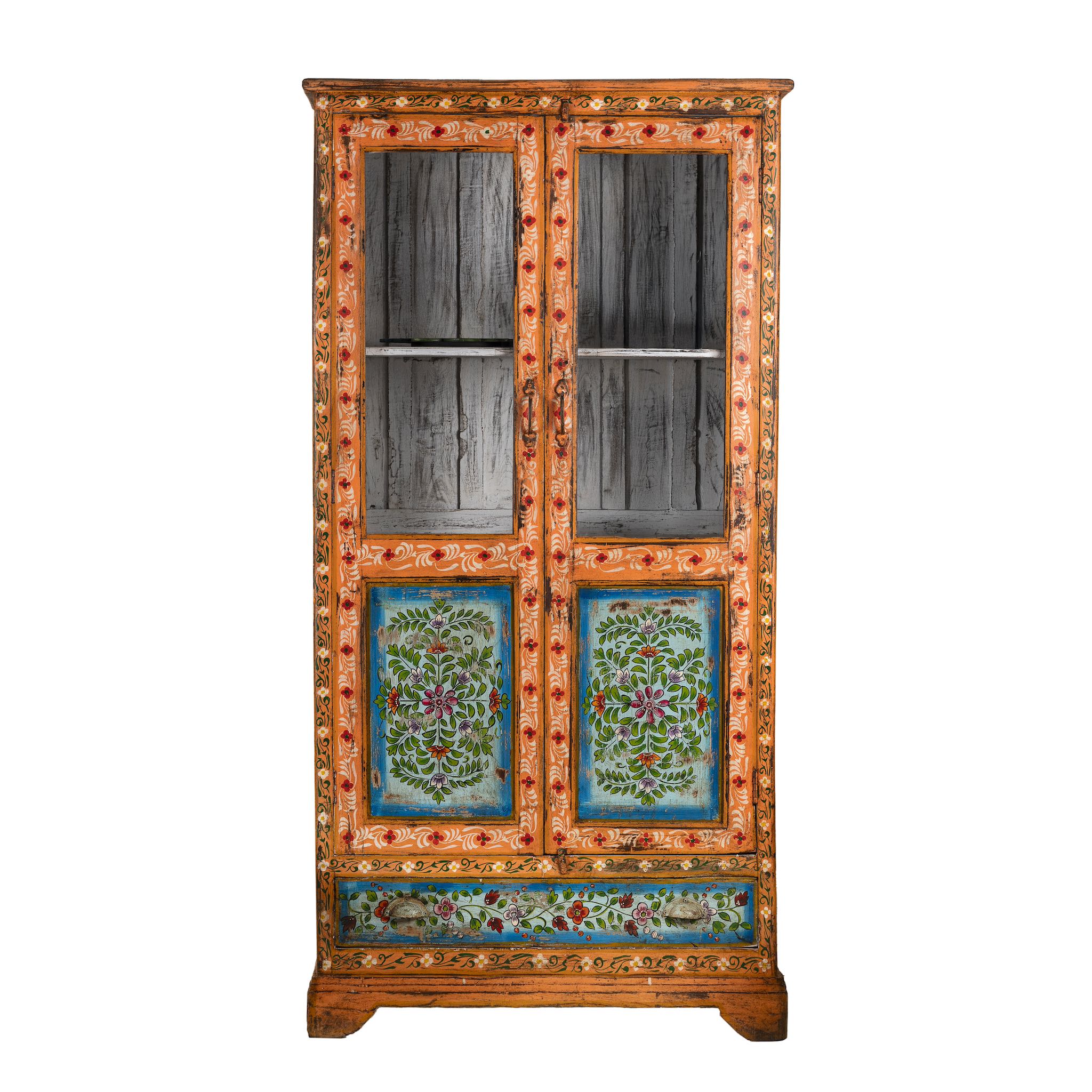 White background image of a hand-painted teak wood showcase with floral motifs and glass doors – sustainable furniture crafted from recycled wood with traditional Indian artistry.