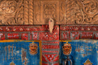 Close up image of a hand-painted cabinet made from reclaimed teak wood with colourful Indian motifs – sustainable furniture and vintage teak wood craftsmanship for bold interiors.