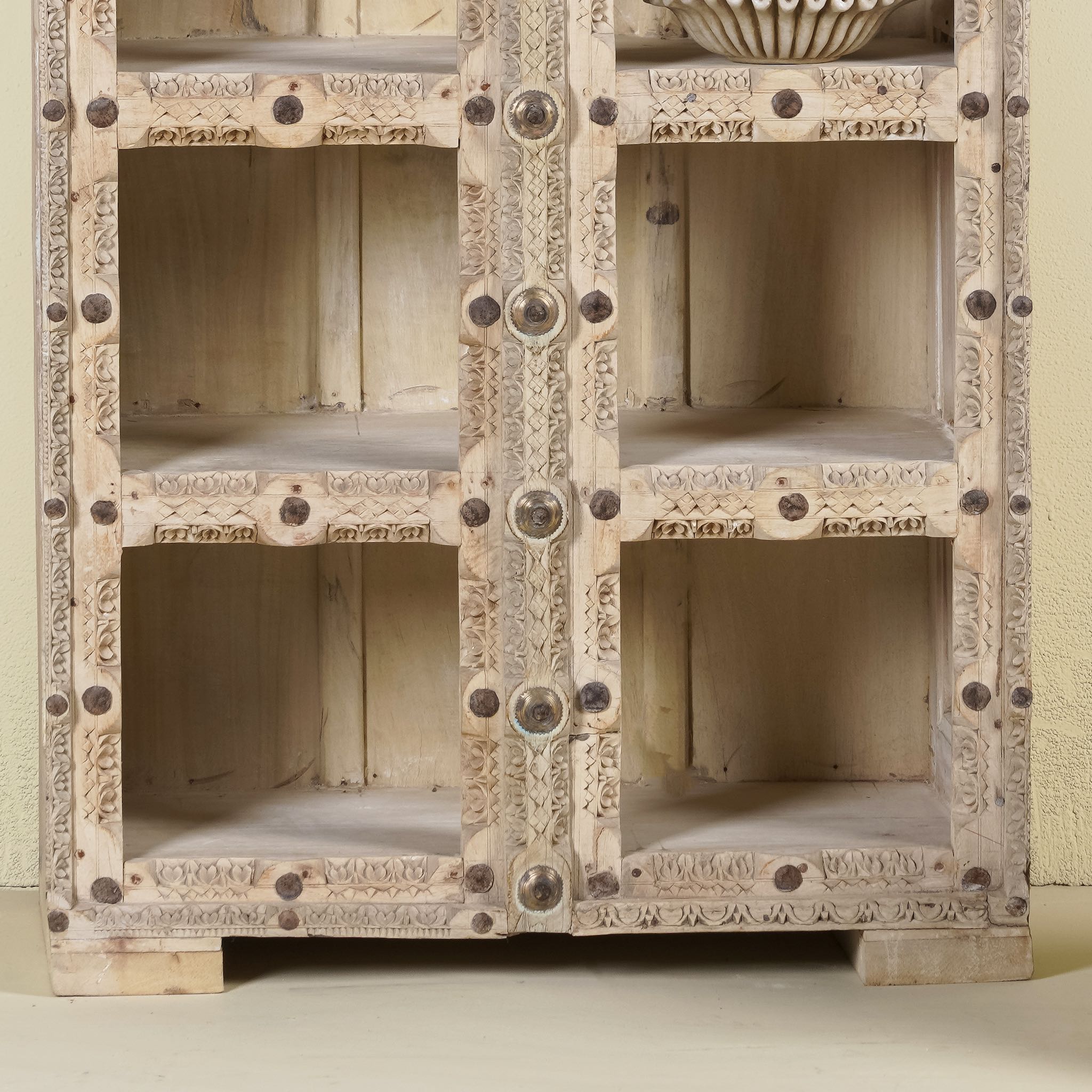 Close up image of a reclaimed teak wood shelving unit with 10 compartments and iron fittings – sustainable furniture combining practicality, style, and handcrafted quality.