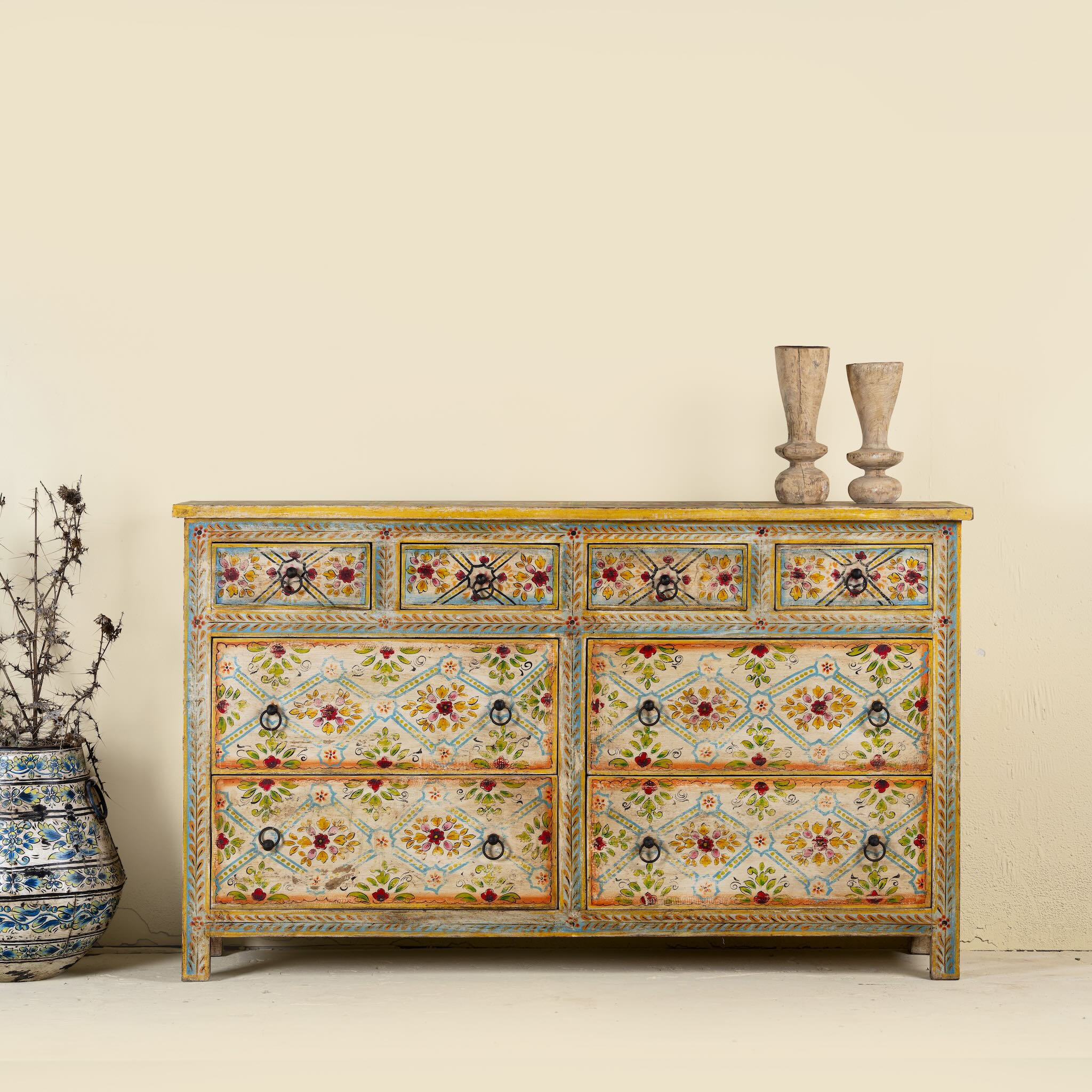 Ziya hand‑painted chest of 8 drawers made from reclaimed wood with floral motifs and iron handles—an artisan piece of painted wooden furniture.
