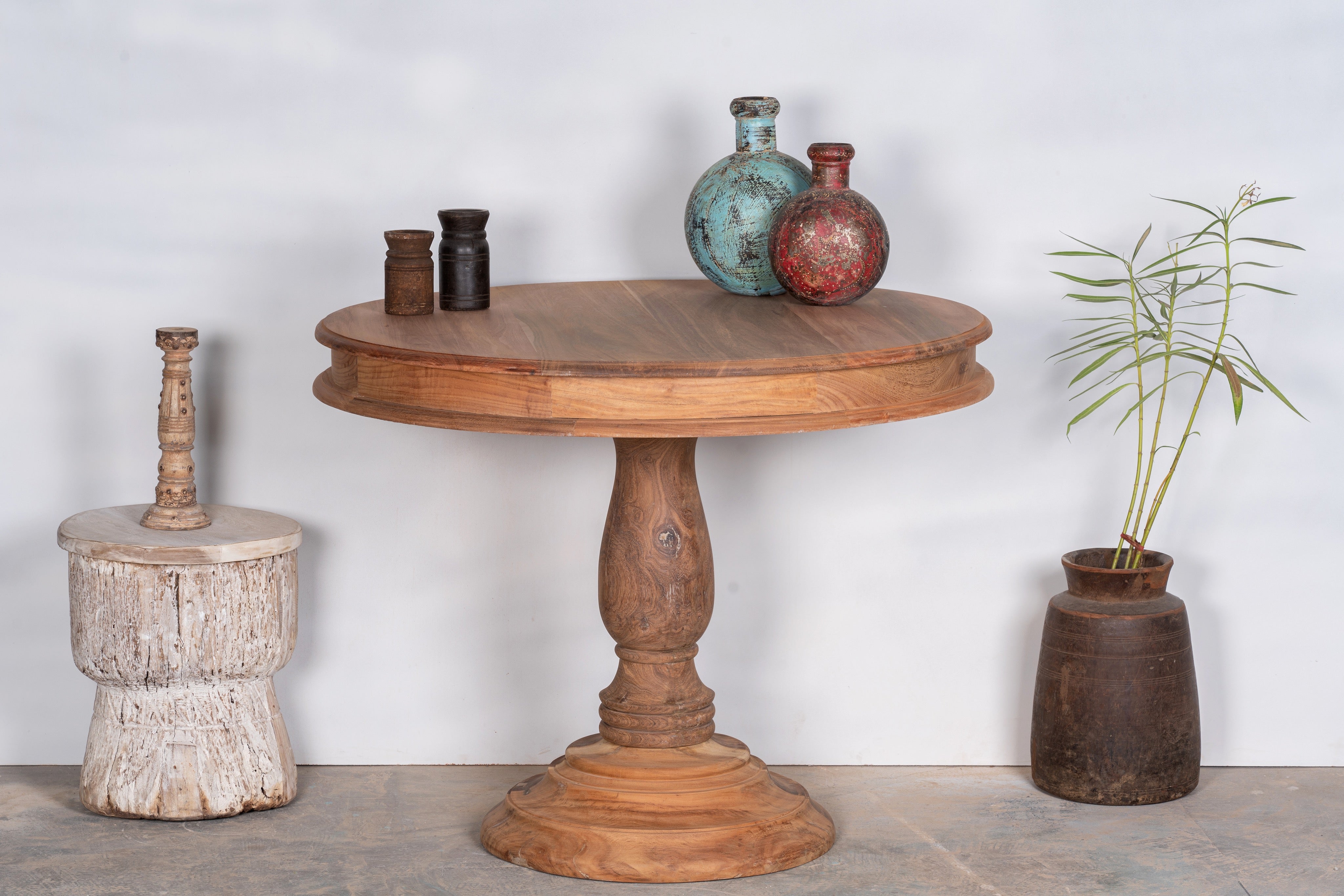 Round solid wood dining table made from reclaimed teak with carved pedestal base; rustic reclaimed teak wood dining table, 100 cm diameter × 78 cm height.