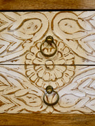 Close up image of a white washed mango wood console table with floral hand-carved drawers and lower shoe shelf; rustic mango wood furniture, 90 × 40 × 75 cm.