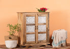 Side angle image of a carved sideboard / bedroom furniture in mango wood with white-washed floral engravings, 90 × 40 × 100 cm.