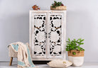 White washed mango wood cabinet with three compartments and hand‑carved floral doors, vintage style, 75 × 40 × 120 cm.