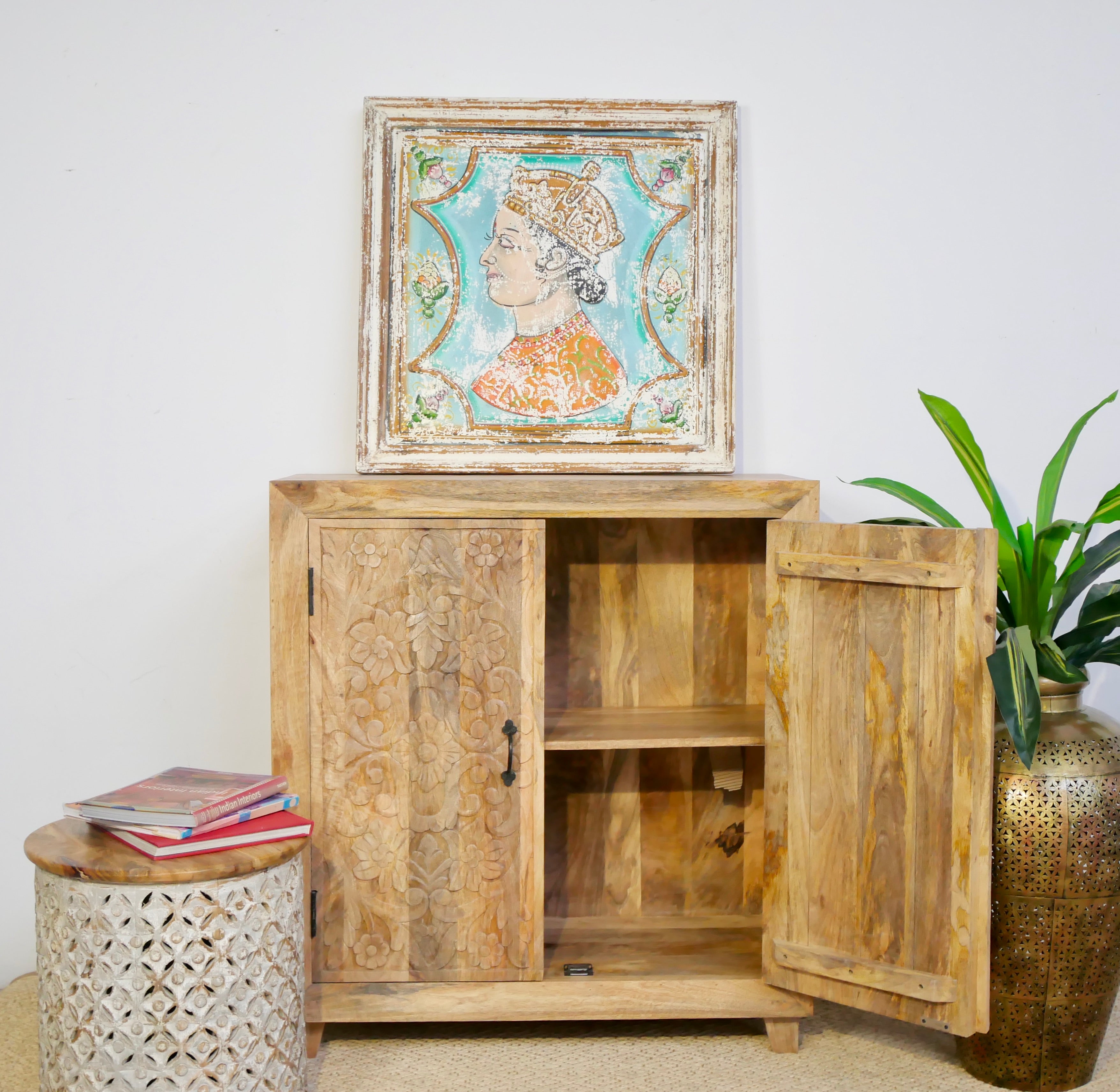 Open door image of a carved wood furniture cabinet made from solid mango wood, hand-carved floral design, Mediterranean-style, 90 × 97 × 40 cm.